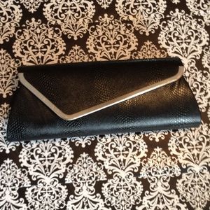 Black snake skin envelope clutch. Silver trim.